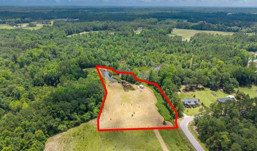 View of property location featuring a forest and p
