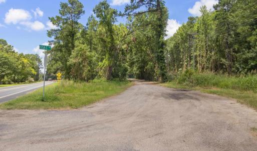 View of asphalt street with a wooded view and traf