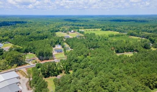 View of property location with a heavily wooded ar