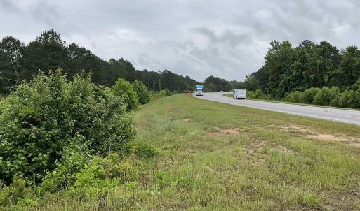 View of yard with a view of trees