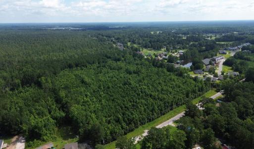 View of property location featuring a forest
