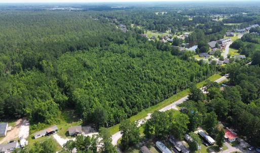 Aerial view of property's location with a forest