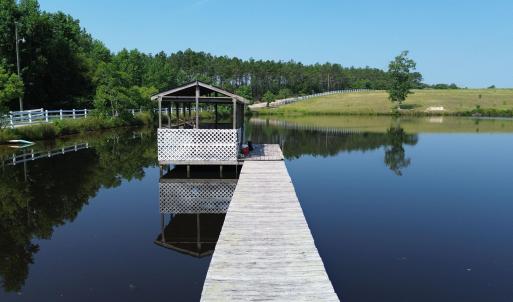 Dock area with a water view and a view of trees