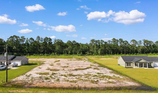 View of property's community featuring a lawn