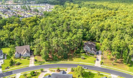 Aerial view of residential area featuring a heavil