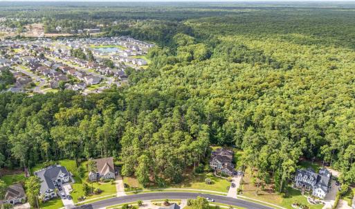 View of property location featuring a forest and n