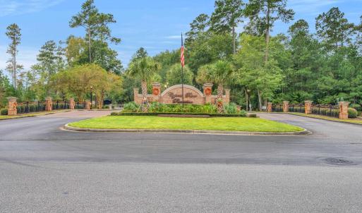Community sign with view of wooded area