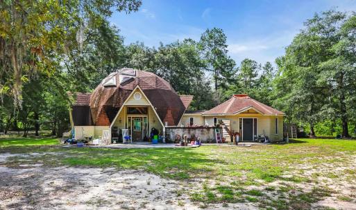 Back of property with a gambrel roof and view of w