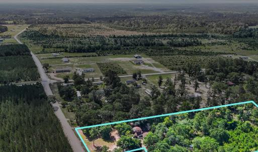 View of rural area with a forest and property parc