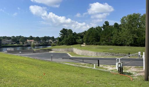 View of street featuring curbs, a water view, stre