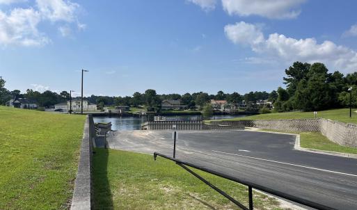 View of asphalt street with a water view, curbs, a
