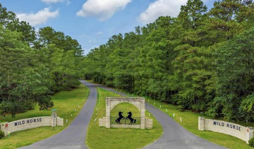 View of property's community featuring a yard and