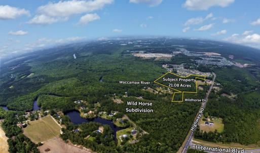 View of property location with a forest and proper