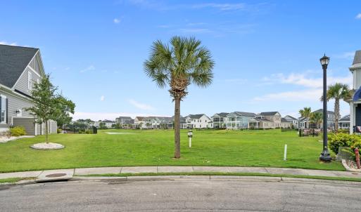 View of green lawn with a residential view