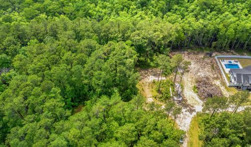 View of property location with a heavily wooded ar