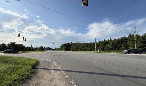 View of asphalt road featuring traffic lights