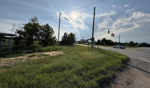 View of asphalt road featuring traffic lights