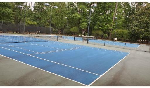 View of tennis court featuring community basketbal