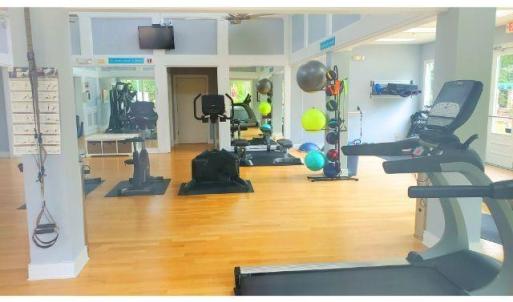 Workout area with wood finished floors and plenty