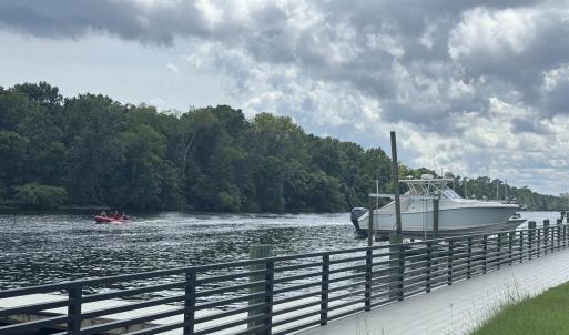 Dock with a water view and a wooded view