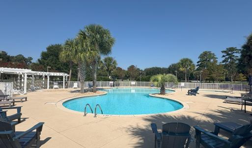 Community pool featuring a patio and a pergola