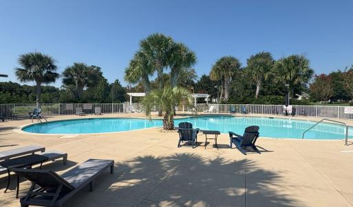 Community pool with a patio
