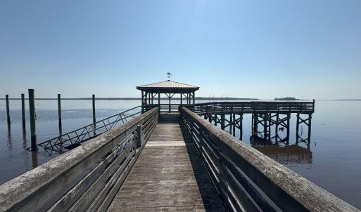 Dock featuring a water view, a gazebo, and a pier