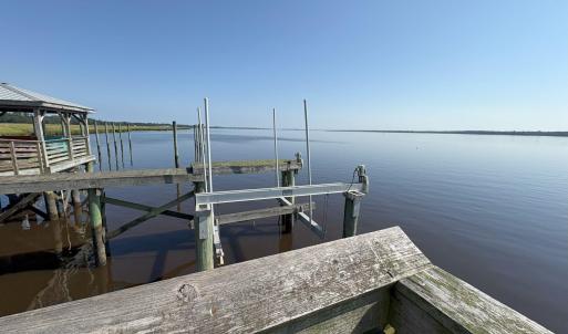 Dock area with boat lift and a water view
