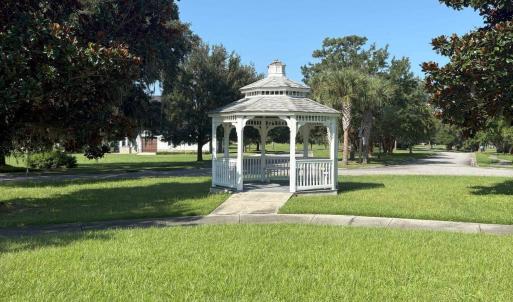 View of property's community featuring a yard, a g