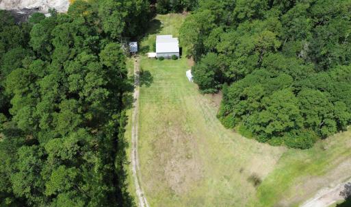 View of property location featuring a forest