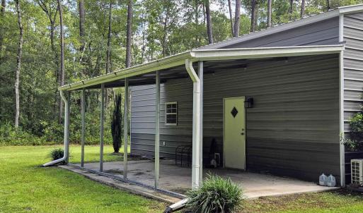 View of outdoor structure featuring view of wooded