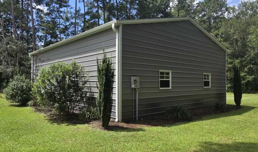 View of property exterior featuring a lawn
