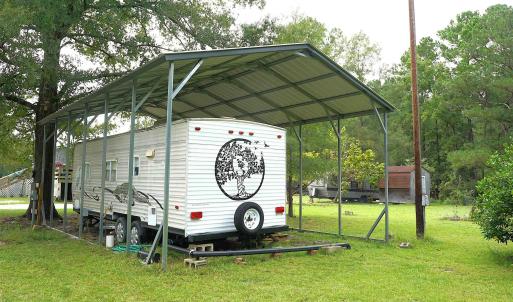 View of vehicle parking featuring a carport and vi