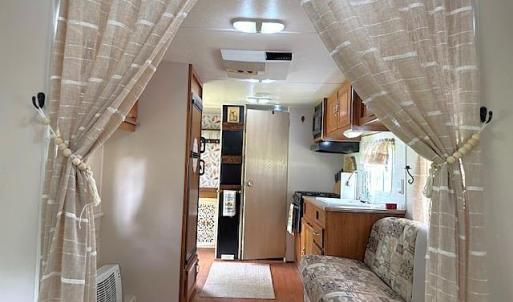 Kitchen featuring wood finished floors, brown cabi