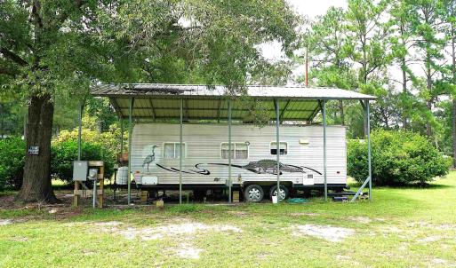 View of parking / parking lot with a carport and v
