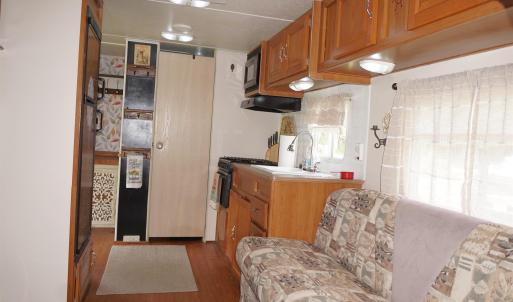 Kitchen featuring dark wood-type flooring, brown c