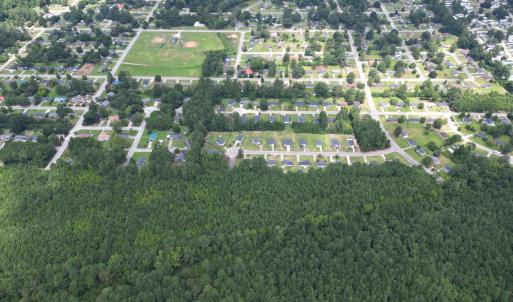 Aerial view of property's location with a forest
