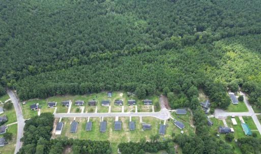 View of property location with a heavily wooded ar