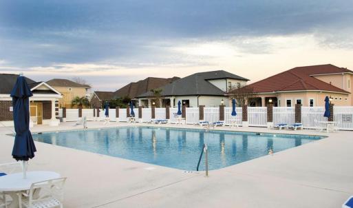 Community pool with a patio