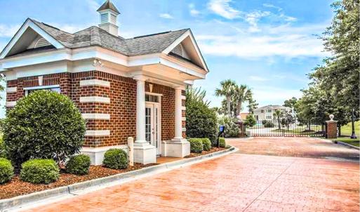 Doorway to property with brick siding, a porch, an