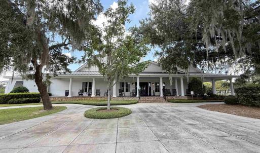 Farmhouse-style home with a large porch and curved