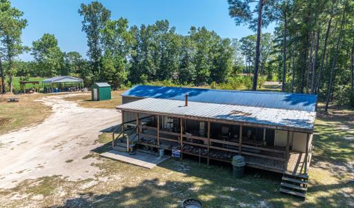Rear view of property with a carport, a metal roof