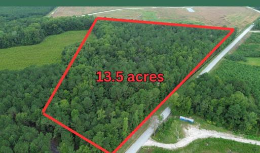 View of property location with a forest and proper