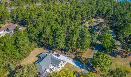View of property location with a heavily wooded ar
