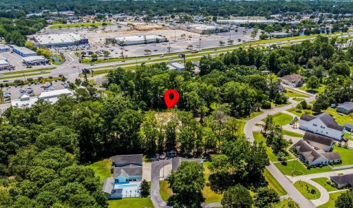 Aerial view of property's location featuring a tre