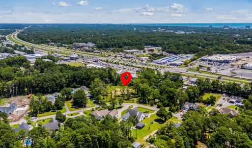 Aerial view of property's location with a tree fil