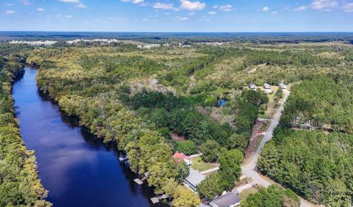 Aerial view of a heavily wooded area and a large b
