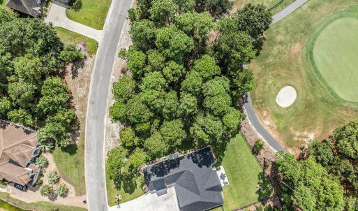 Aerial overview of property's location with a golf