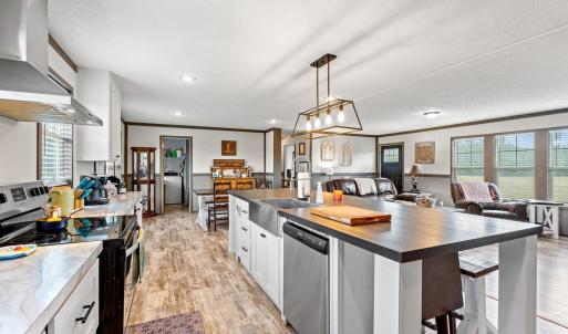 Kitchen with white cabinets, range with electric s
