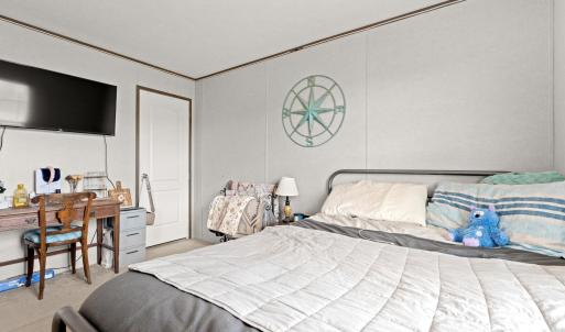 Bedroom with carpet, ornamental molding, and a des